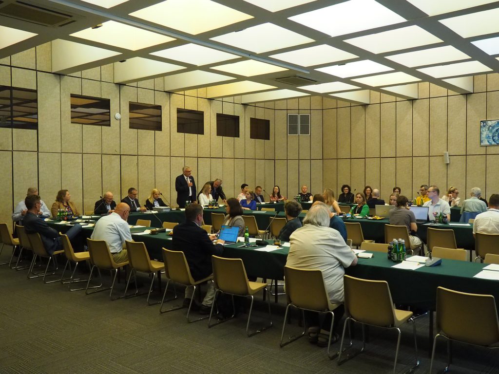 Representatives of the Scientific Council of IBCH PAS sit in the conference room and listen to the speaker's delivery during the 141st plenary meeting of the Scientific Council
