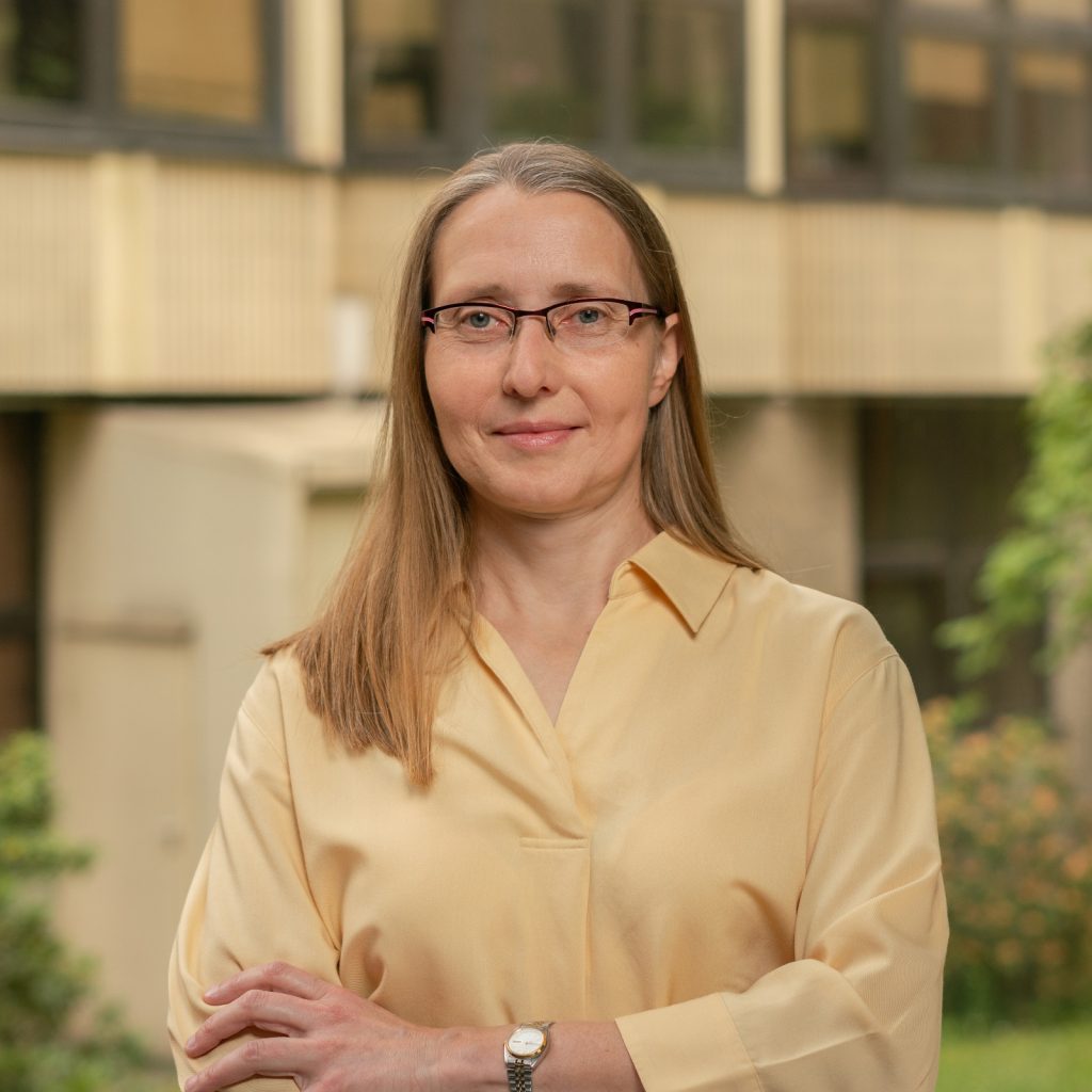 Portrait photograph by Prof. Elżbieta Kierzek. Elegantly dressed woman with long light hair, smiling gently.

