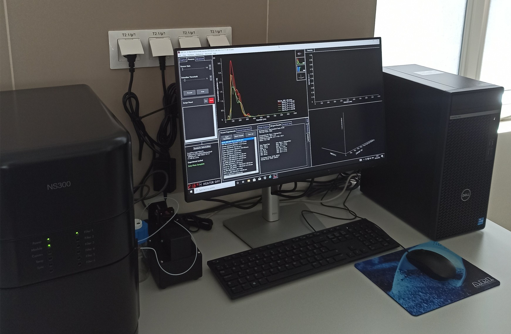 Nanosight NS3000 instrument with particle analysis results displayed on the computer screen showing graphs.