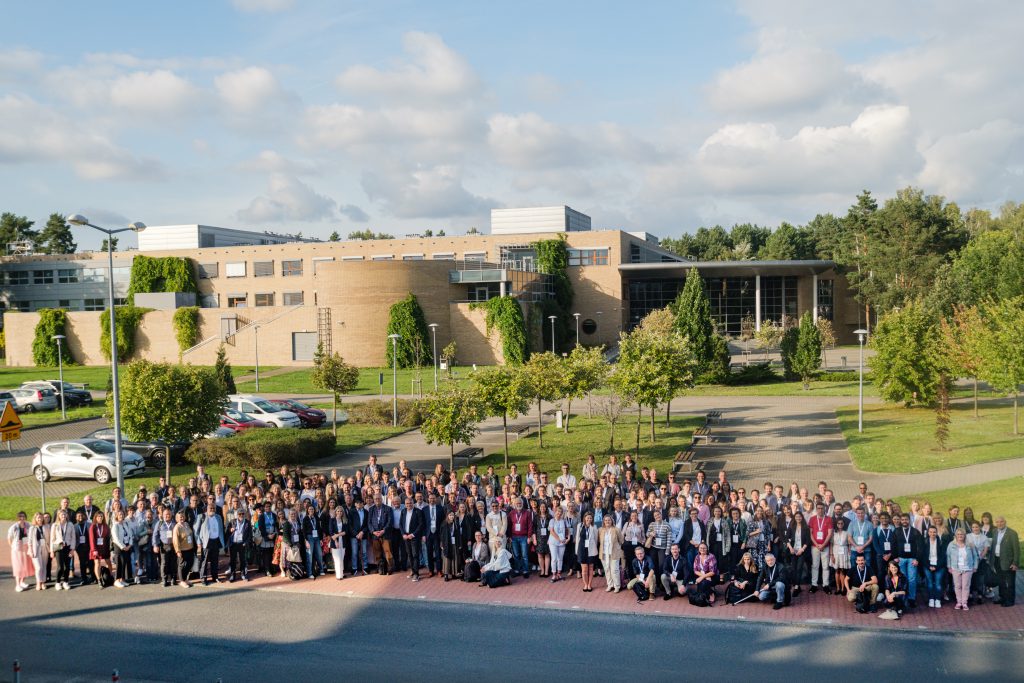 Group photo of conference participants in front of the Faculty of Biology, Adam Mickiewicz University