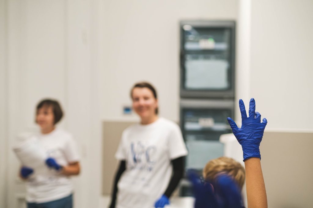 A hand raised in a glove.