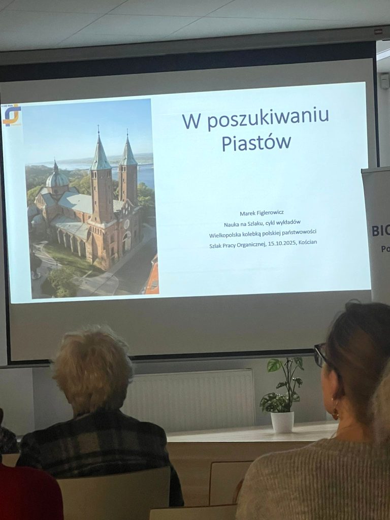 The slide titled "In Search of the Piasts" is shown; Prof. Figlerowicz is discussing the results of the project.
