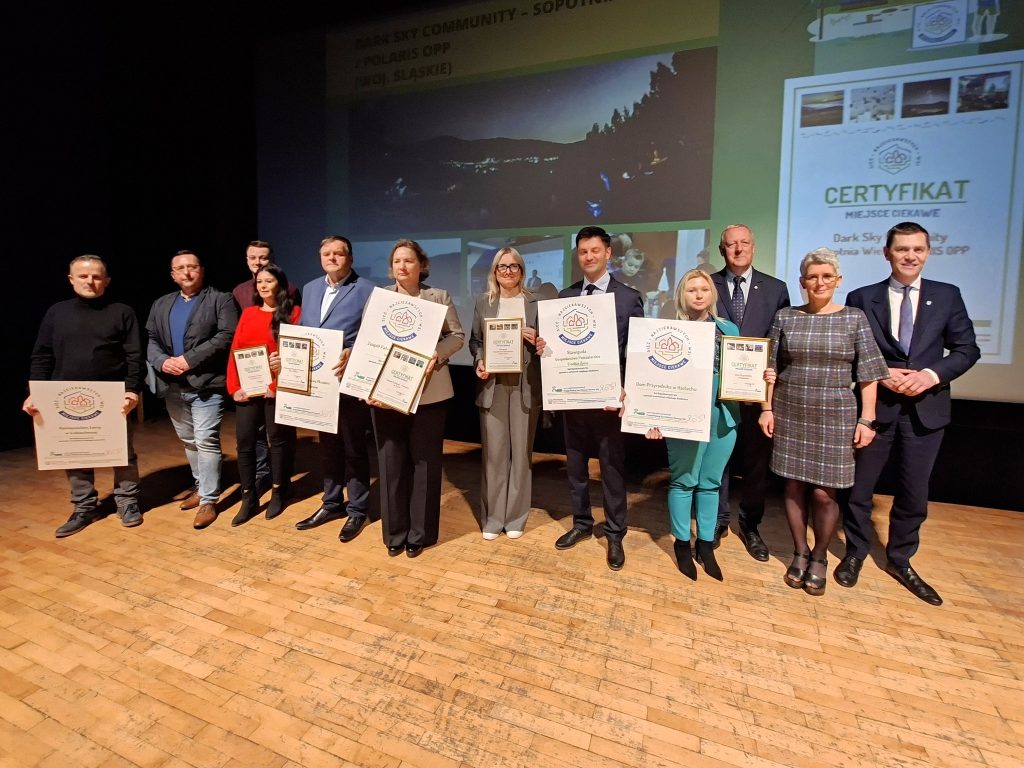 The winners with their certificates on stage